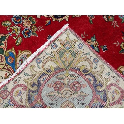 1386 - Carpet / Rug : A Persian Tabriz carpet, the red and cream grounds decorated with vignettes depicting... 