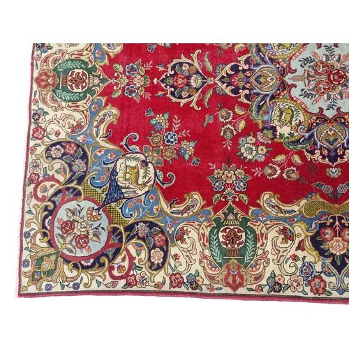 1386 - Carpet / Rug : A Persian Tabriz carpet, the red and cream grounds decorated with vignettes depicting... 