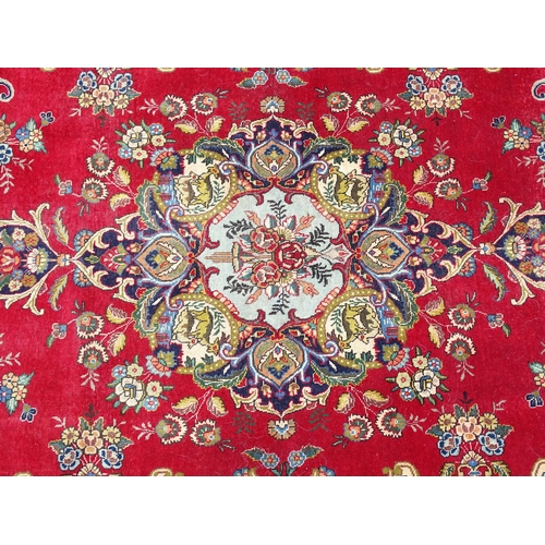 1386 - Carpet / Rug : A Persian Tabriz carpet, the red and cream grounds decorated with vignettes depicting... 