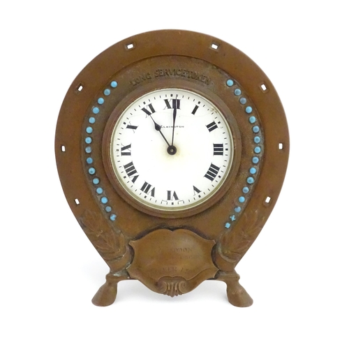 1399 - A presentation mantle clock the surround of horseshoe form with turquoise coloured cabochon detail t... 