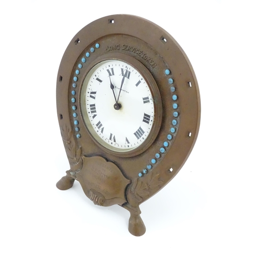 1399 - A presentation mantle clock the surround of horseshoe form with turquoise coloured cabochon detail t... 