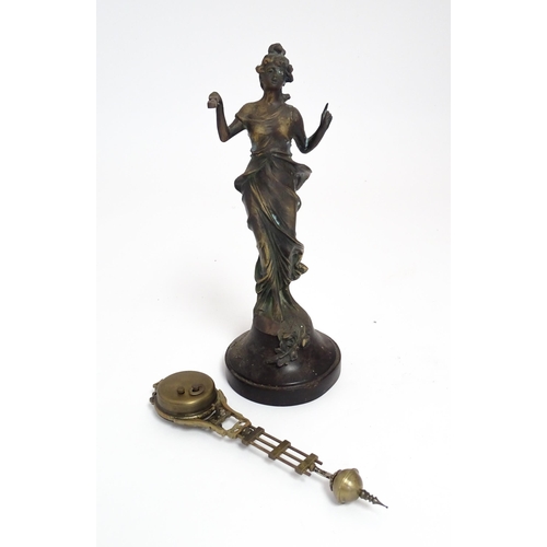 1403 - A Junghans Mystery ( swinging) clock  formed as a spelter lady holding aloft a clock suspended from ... 