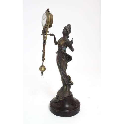 1403 - A Junghans Mystery ( swinging) clock  formed as a spelter lady holding aloft a clock suspended from ... 