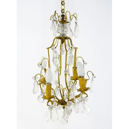 1438 - A 20thC French hanging pendant electrolier having four branches and hanging lustres. Approx. 21