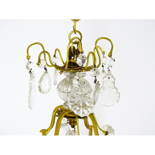 1438 - A 20thC French hanging pendant electrolier having four branches and hanging lustres. Approx. 21