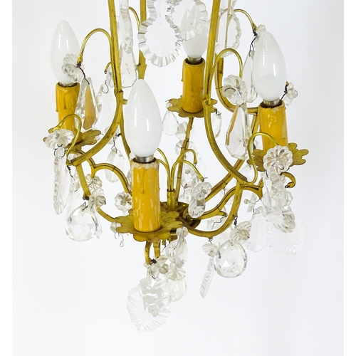 1438 - A 20thC French hanging pendant electrolier having four branches and hanging lustres. Approx. 21