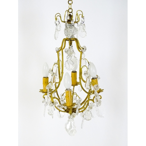 1438 - A 20thC French hanging pendant electrolier having four branches and hanging lustres. Approx. 21