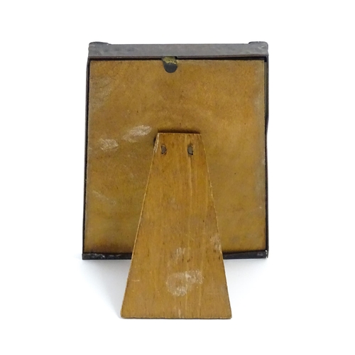 1004 - An Arts & Crafts style easel back photograph frame of tapering form with hammered copper surround an... 