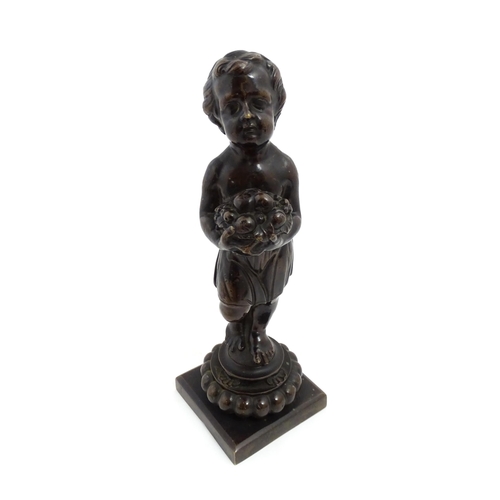 1009 - A 19thC cast bronze sculpture modelled as a young boy holding a basket of fruit. Approx. 11