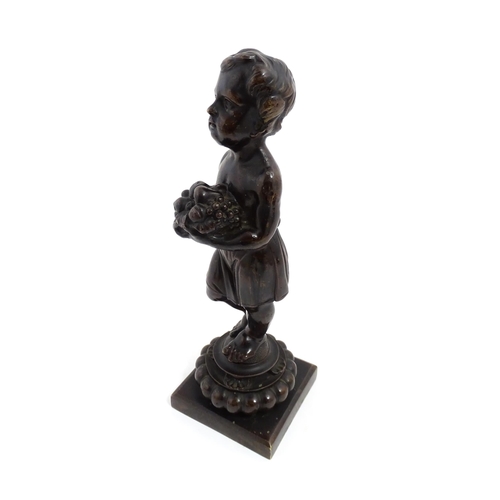 1009 - A 19thC cast bronze sculpture modelled as a young boy holding a basket of fruit. Approx. 11