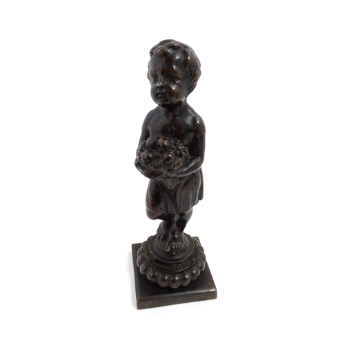 1009 - A 19thC cast bronze sculpture modelled as a young boy holding a basket of fruit. Approx. 11