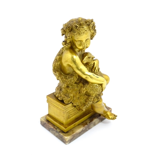 1011 - A 19thC cast and gilt sculpture modelled as Saint John the Baptist as a child holding a lamb, raised... 