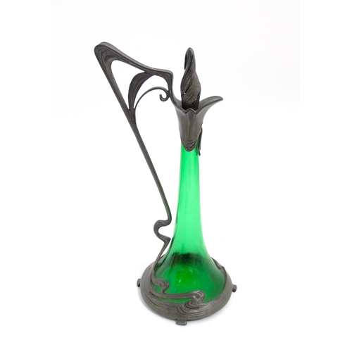 1012 - An Art Nouveau green glass and pewter decanter and two pedestal glasses with tendril detail. In the ... 