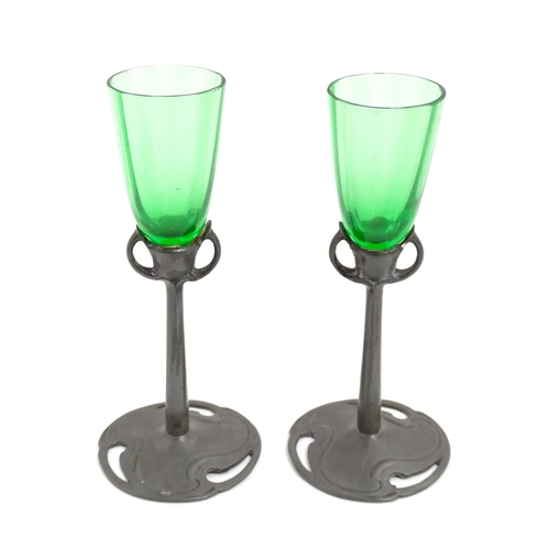 1012 - An Art Nouveau green glass and pewter decanter and two pedestal glasses with tendril detail. In the ... 