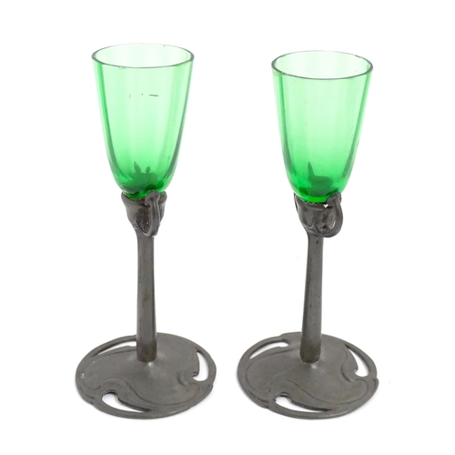 1012 - An Art Nouveau green glass and pewter decanter and two pedestal glasses with tendril detail. In the ... 