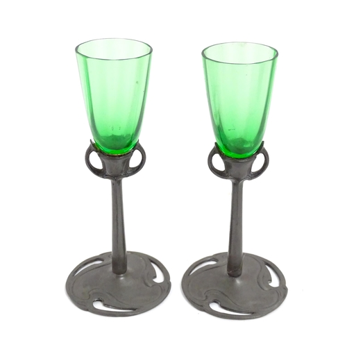 1012 - An Art Nouveau green glass and pewter decanter and two pedestal glasses with tendril detail. In the ... 