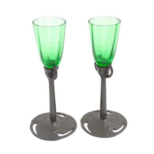 1012 - An Art Nouveau green glass and pewter decanter and two pedestal glasses with tendril detail. In the ... 