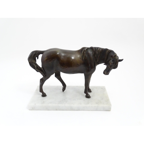 1015 - A 20thC cast sculpture modelled as a standing horse, raised on a marble base. Approx. 7 1/4