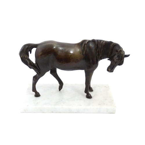 1015 - A 20thC cast sculpture modelled as a standing horse, raised on a marble base. Approx. 7 1/4