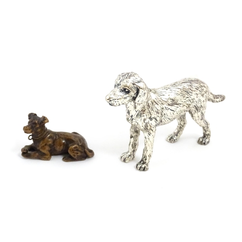 1017 - A small late 19th / early 20thC bronze model of a dog / hound. Together with a silver plate model of... 