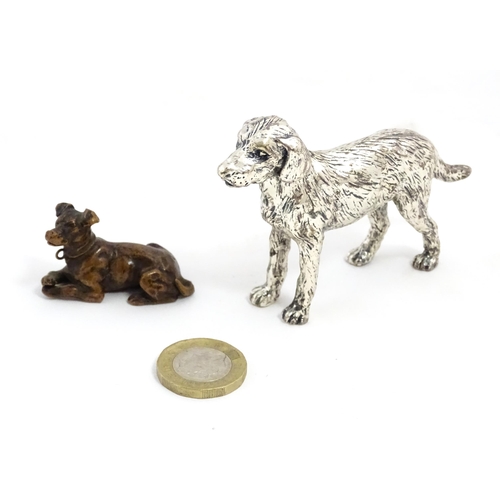 1017 - A small late 19th / early 20thC bronze model of a dog / hound. Together with a silver plate model of... 