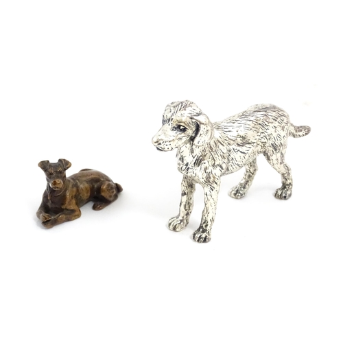 1017 - A small late 19th / early 20thC bronze model of a dog / hound. Together with a silver plate model of... 