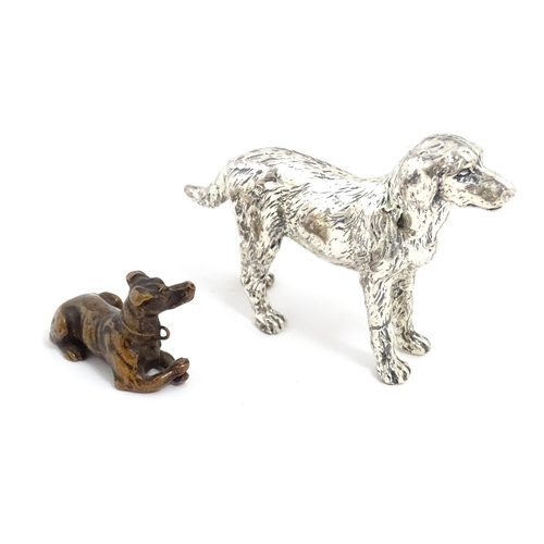 1017 - A small late 19th / early 20thC bronze model of a dog / hound. Together with a silver plate model of... 