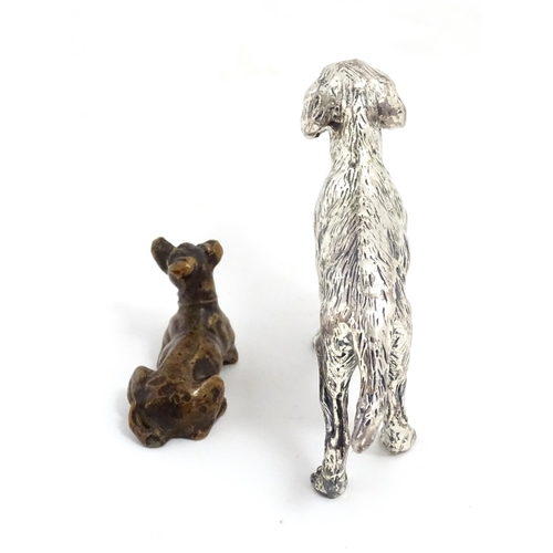 1017 - A small late 19th / early 20thC bronze model of a dog / hound. Together with a silver plate model of... 