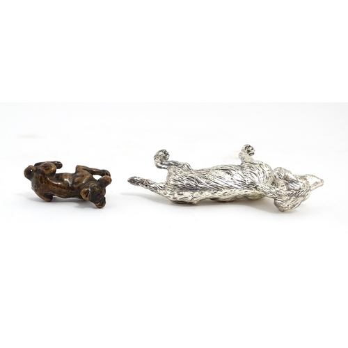 1017 - A small late 19th / early 20thC bronze model of a dog / hound. Together with a silver plate model of... 