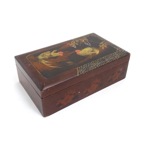 1032 - An Oriental lacquered box with hand painted cockerel decoration, opening to reveal inlaid marquetry ... 