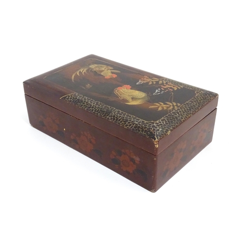 1032 - An Oriental lacquered box with hand painted cockerel decoration, opening to reveal inlaid marquetry ... 