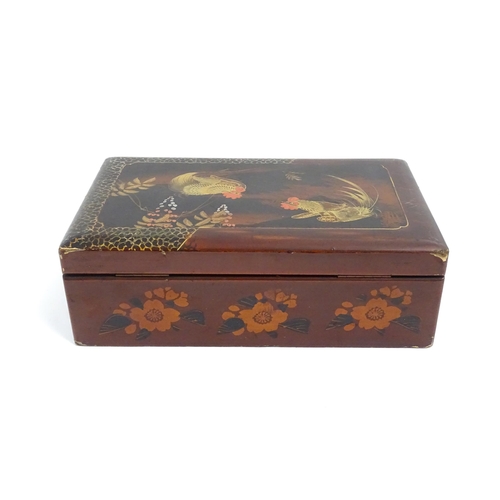 1032 - An Oriental lacquered box with hand painted cockerel decoration, opening to reveal inlaid marquetry ... 