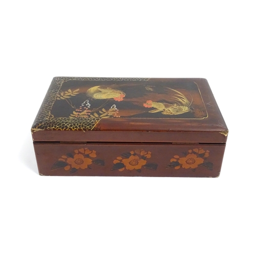 1032 - An Oriental lacquered box with hand painted cockerel decoration, opening to reveal inlaid marquetry ... 