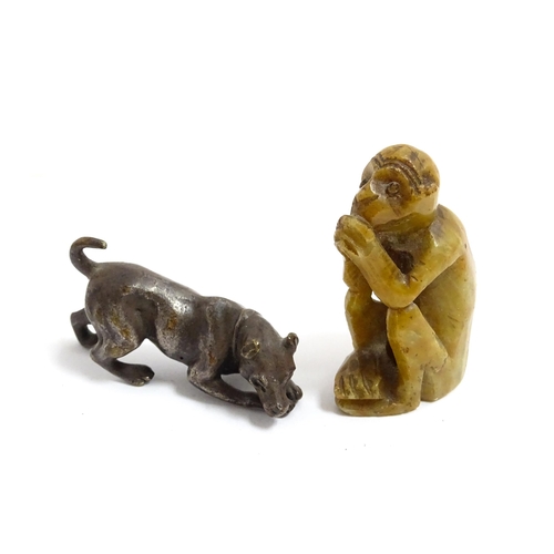 1038 - A Chinese carved soapstone model of a monkey. Together with an early 20thC bronze model of a dog / h... 