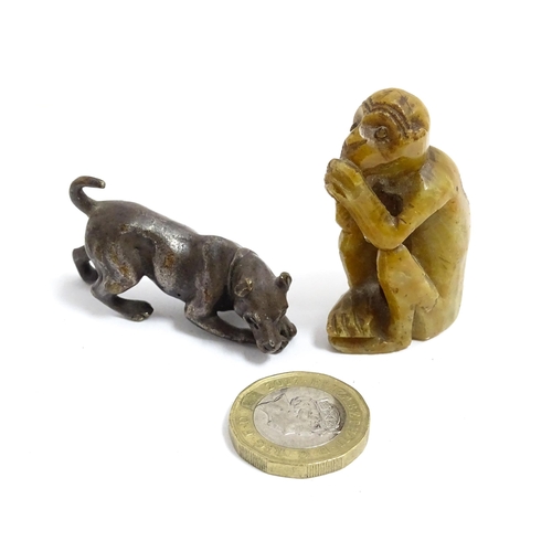 1038 - A Chinese carved soapstone model of a monkey. Together with an early 20thC bronze model of a dog / h... 