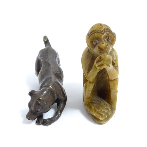 1038 - A Chinese carved soapstone model of a monkey. Together with an early 20thC bronze model of a dog / h... 