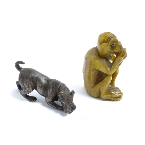 1038 - A Chinese carved soapstone model of a monkey. Together with an early 20thC bronze model of a dog / h... 