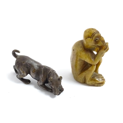 1038 - A Chinese carved soapstone model of a monkey. Together with an early 20thC bronze model of a dog / h... 