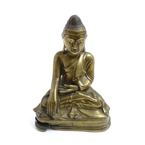 1042 - An Oriental cast sculpture modelled as a seated Buddha. Approx. 8 3/4