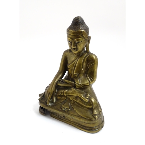 1042 - An Oriental cast sculpture modelled as a seated Buddha. Approx. 8 3/4