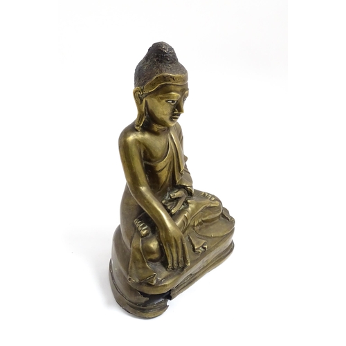 1042 - An Oriental cast sculpture modelled as a seated Buddha. Approx. 8 3/4