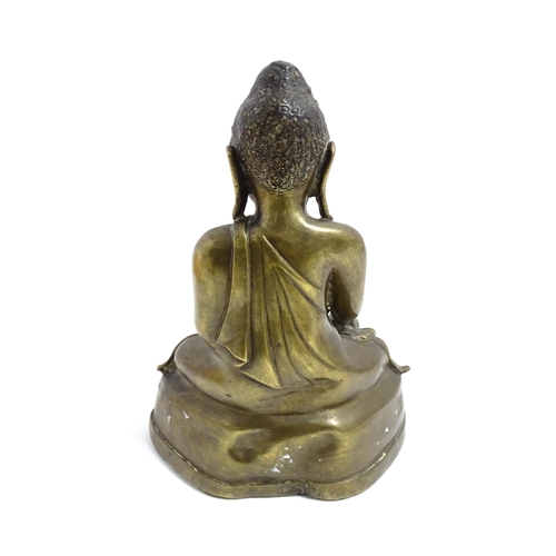 1042 - An Oriental cast sculpture modelled as a seated Buddha. Approx. 8 3/4