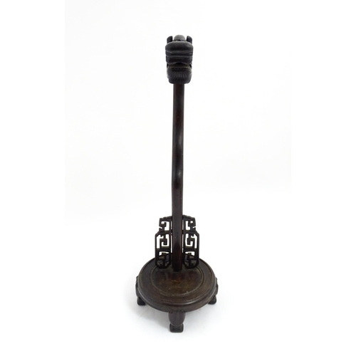 1047 - A Chinese carved hardwood lantern / lamp stand with dragon head and fretwork detail. Approx. 27 3/4