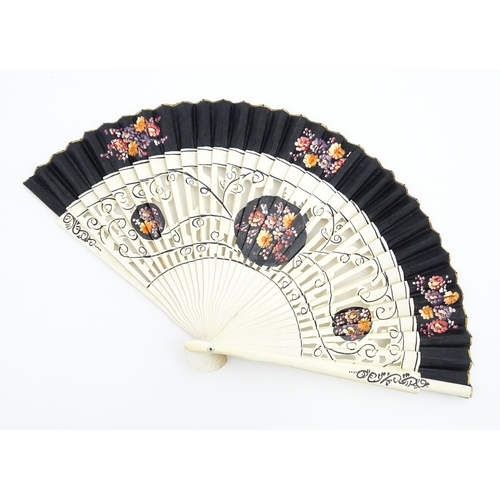 1079 - Three assorted 20thC wooden fans to include a 32 stick example with pierced decoration and hand pain... 