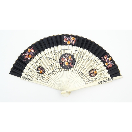 1079 - Three assorted 20thC wooden fans to include a 32 stick example with pierced decoration and hand pain... 