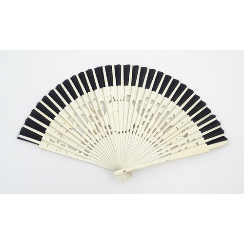 1079 - Three assorted 20thC wooden fans to include a 32 stick example with pierced decoration and hand pain... 