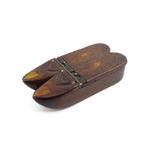 1138 - Treen : A 19thC double shoe snuff box modelled as a pair of shoes with hinged top, carved decoration... 