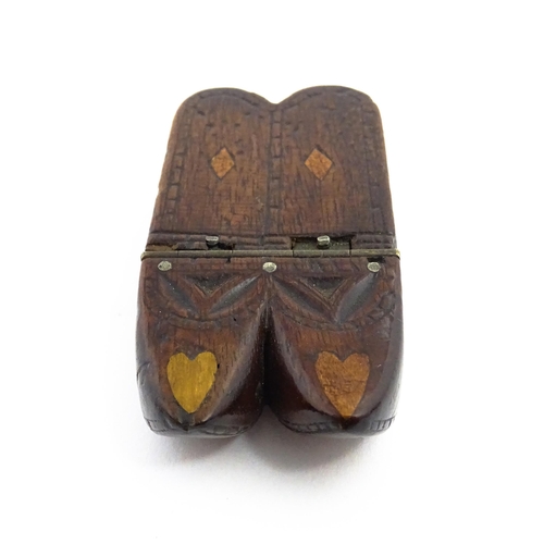 1138 - Treen : A 19thC double shoe snuff box modelled as a pair of shoes with hinged top, carved decoration... 