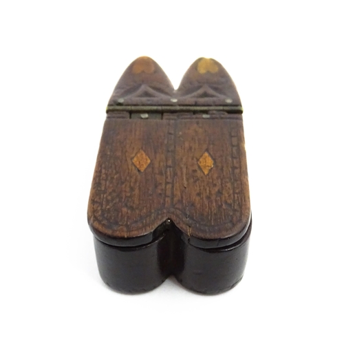 1138 - Treen : A 19thC double shoe snuff box modelled as a pair of shoes with hinged top, carved decoration... 