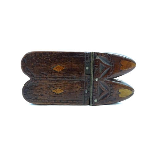 1138 - Treen : A 19thC double shoe snuff box modelled as a pair of shoes with hinged top, carved decoration... 